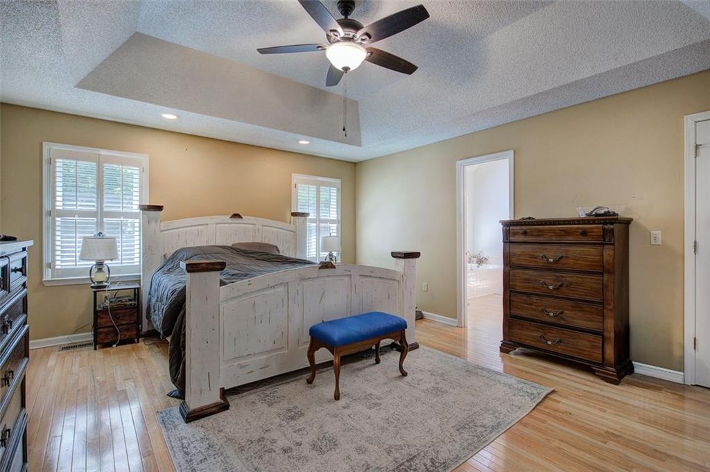 915 Oak Grove Road Carrollton, GA 30117 - Photo 21 of 57 a bedroom with a bed and a chandelier