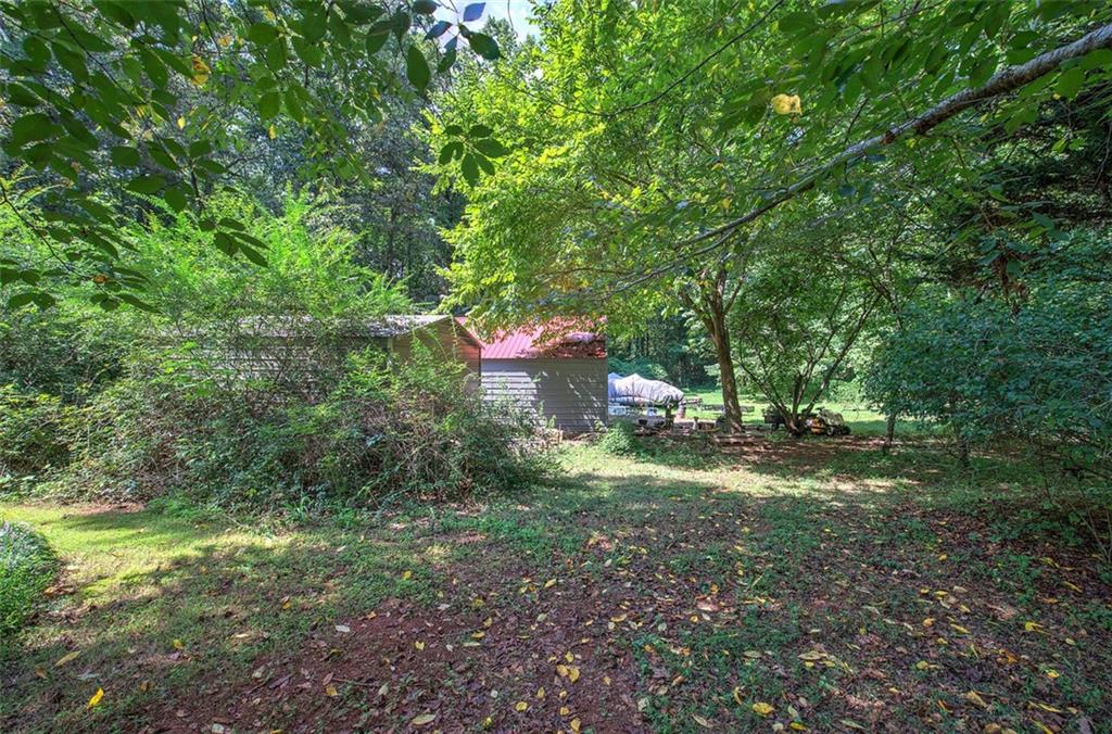 915 Oak Grove Road Carrollton, GA 30117 - Photo 40 of 57 a backyard of a house with a yard and outdoor seating