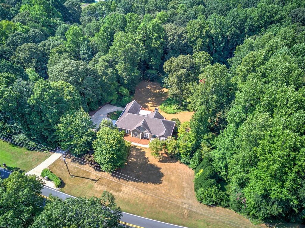 915 Oak Grove Road Carrollton, GA 30117 - Photo 57 of 57 an aerial view of a house with a yard and trees all around