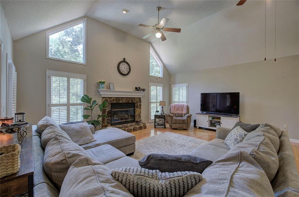 915 Oak Grove Road Carrollton, GA 30117 - Photo 10 of 57 a living room with furniture a fireplace and a flat screen tv