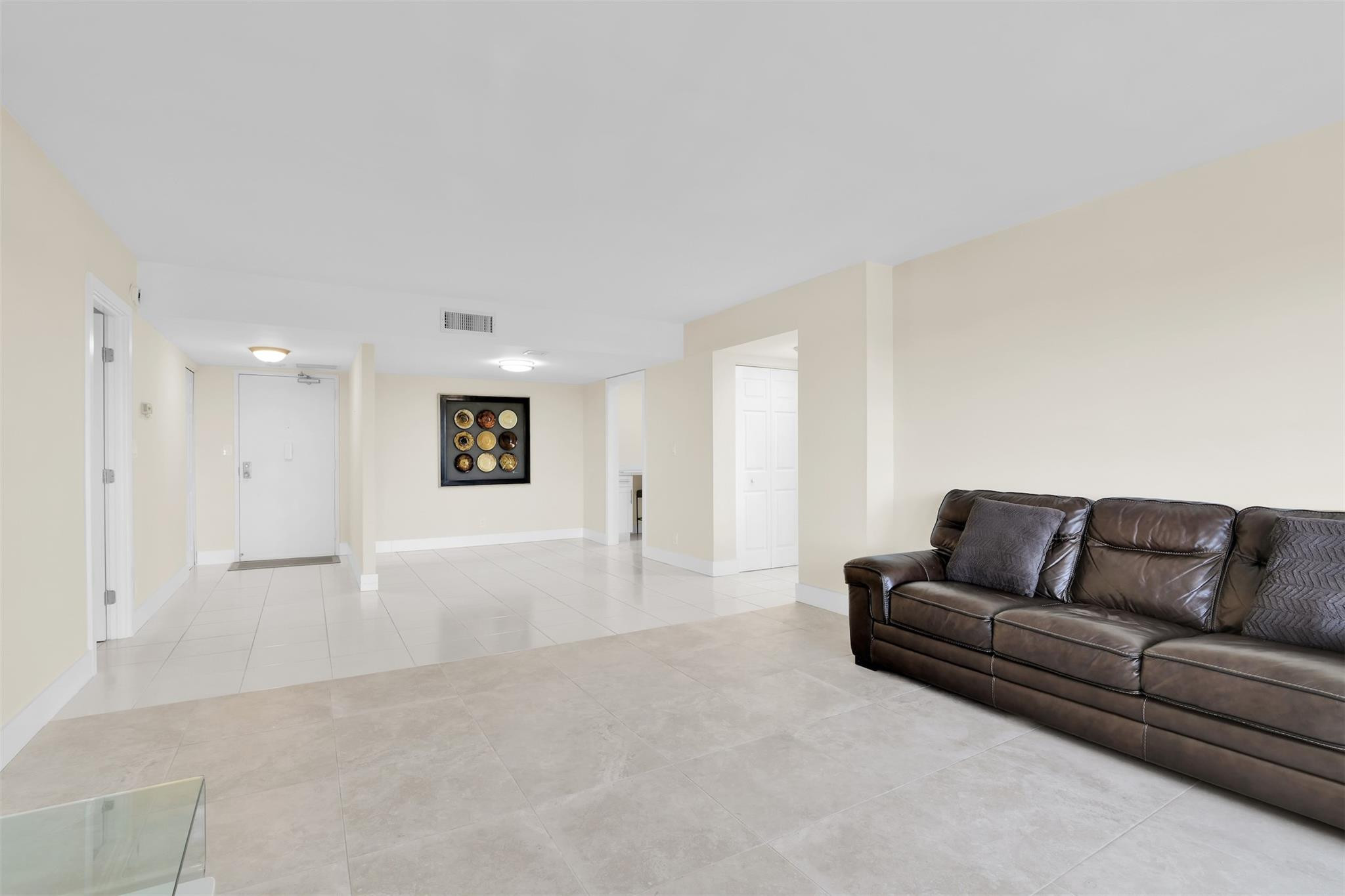 10777 West Sample Road, Unit 711 Coral Springs, FL 33065 - Photo 14 of 45 a living room with furniture and a couch
