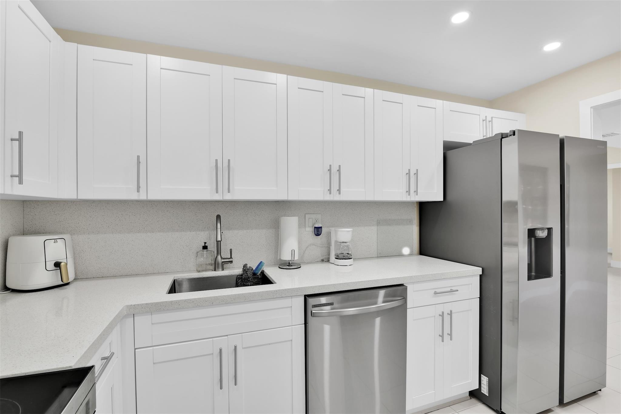 10777 West Sample Road, Unit 711 Coral Springs, FL 33065 - Photo 23 of 45 a kitchen with a refrigerator sink and cabinets