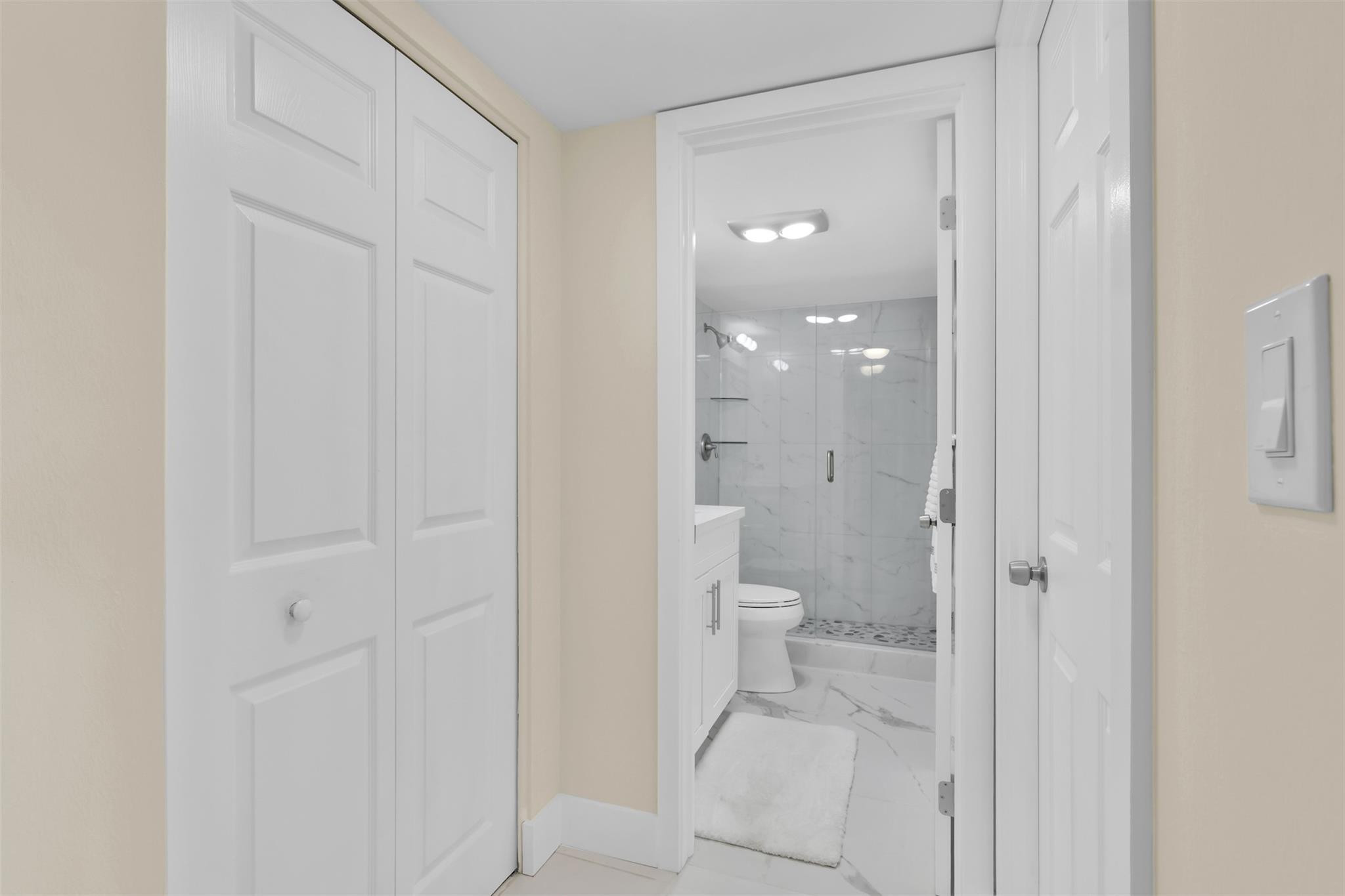 10777 West Sample Road, Unit 711 Coral Springs, FL 33065 - Photo 24 of 45 a bathroom with a granite countertop toilet and a shower