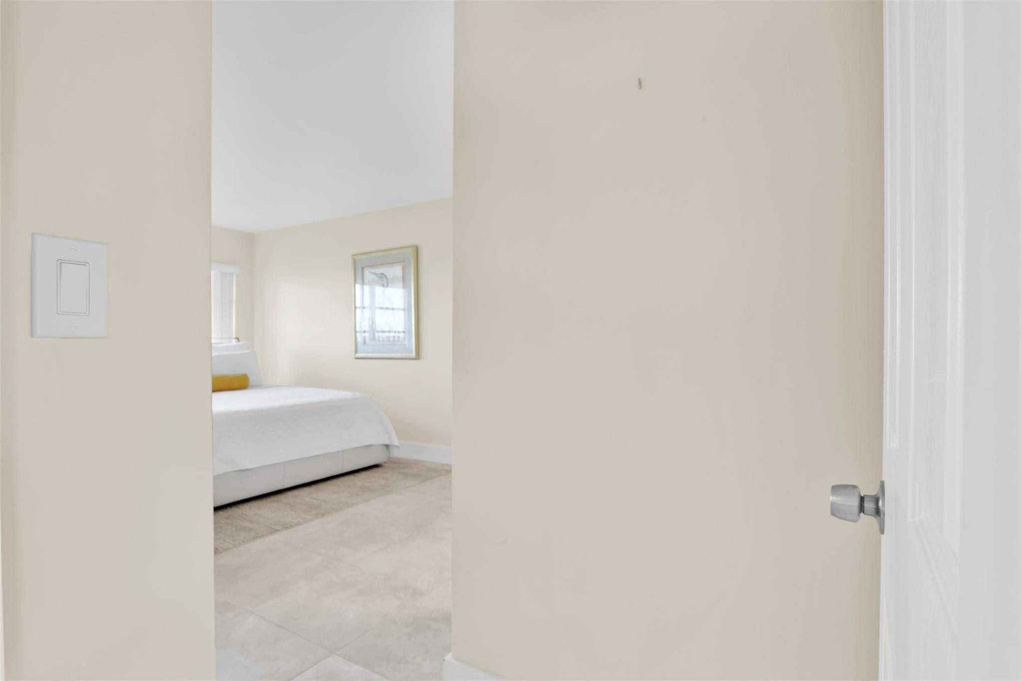 10777 West Sample Road, Unit 711 Coral Springs, FL 33065 - Photo 27 of 45 a bedroom with a white bed and white walls
