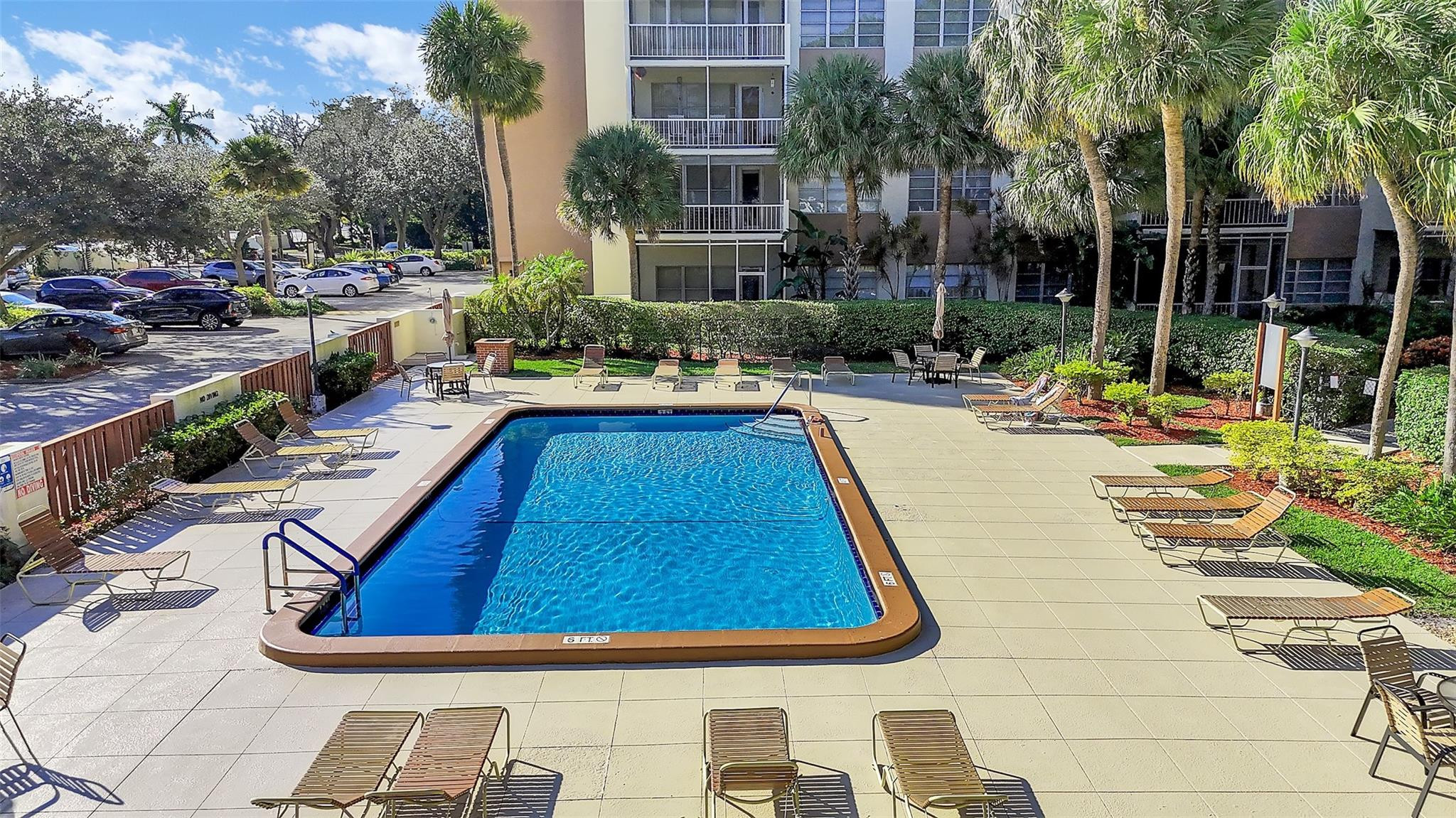 10777 West Sample Road, Unit 711 Coral Springs, FL 33065 - Photo 3 of 45 a view of swimming pool with chairs