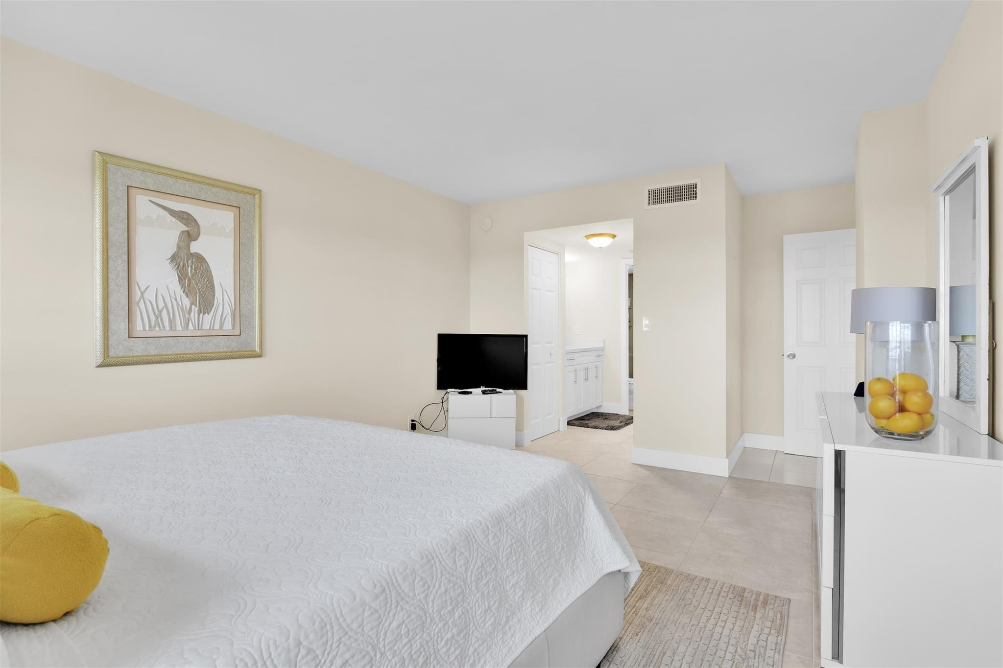 10777 West Sample Road, Unit 711 Coral Springs, FL 33065 - Photo 32 of 45 a bedroom with a bed and painting on the wall