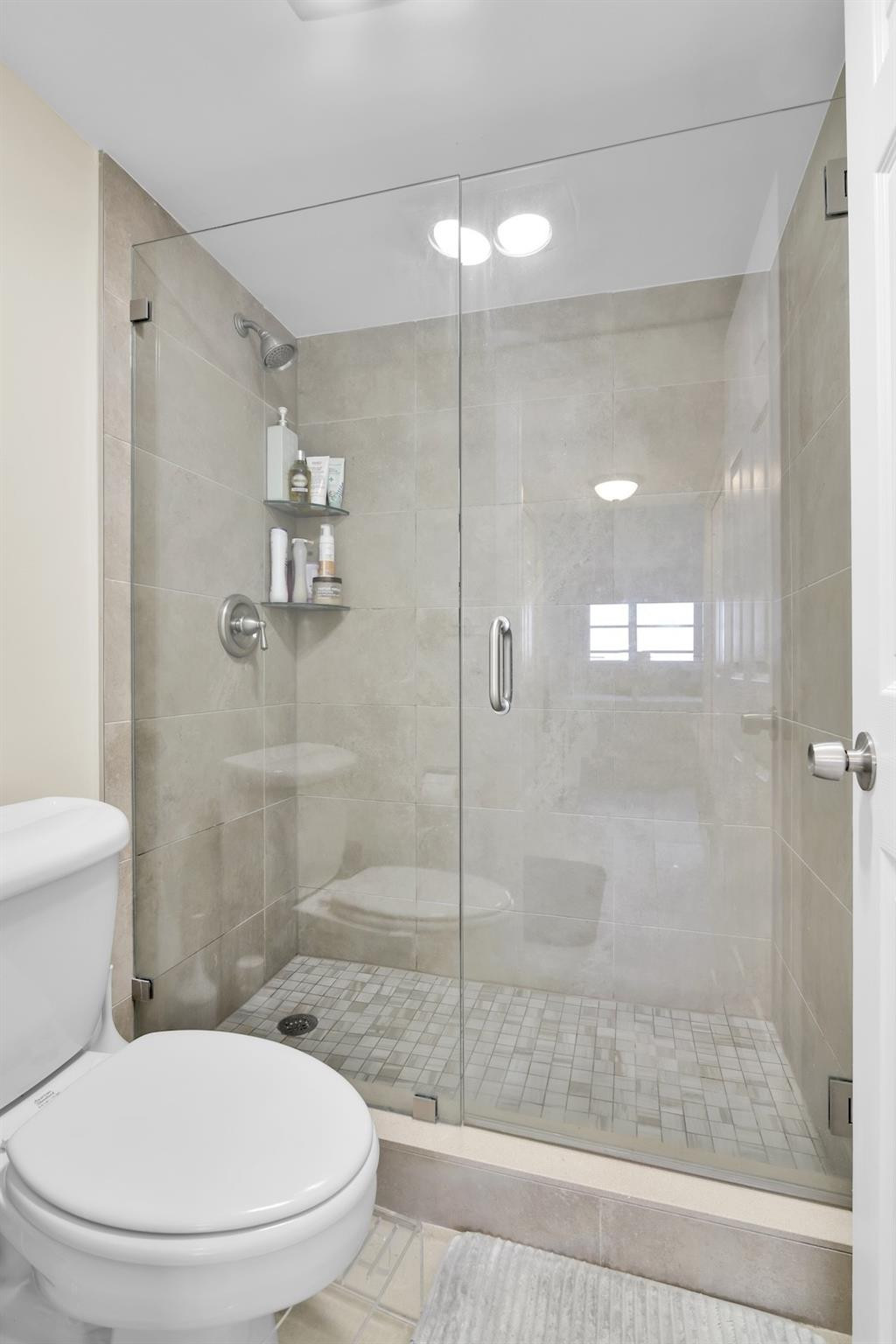 10777 West Sample Road, Unit 711 Coral Springs, FL 33065 - Photo 36 of 45 a bathroom with a toilet and a shower