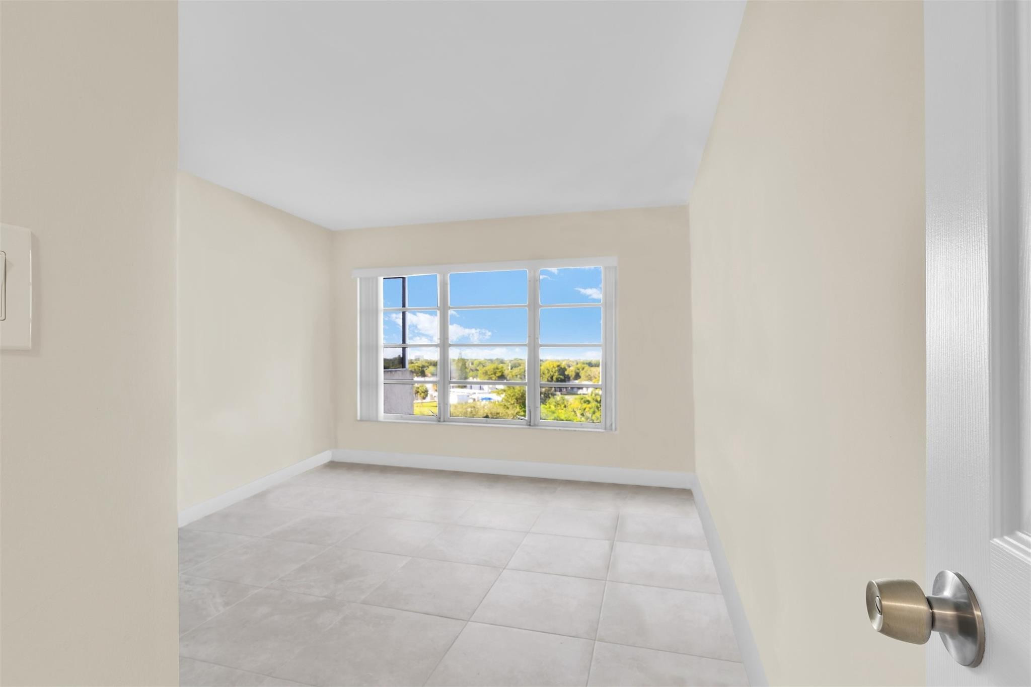 10777 West Sample Road, Unit 711 Coral Springs, FL 33065 - Photo 37 of 45 a view of an empty room with a window