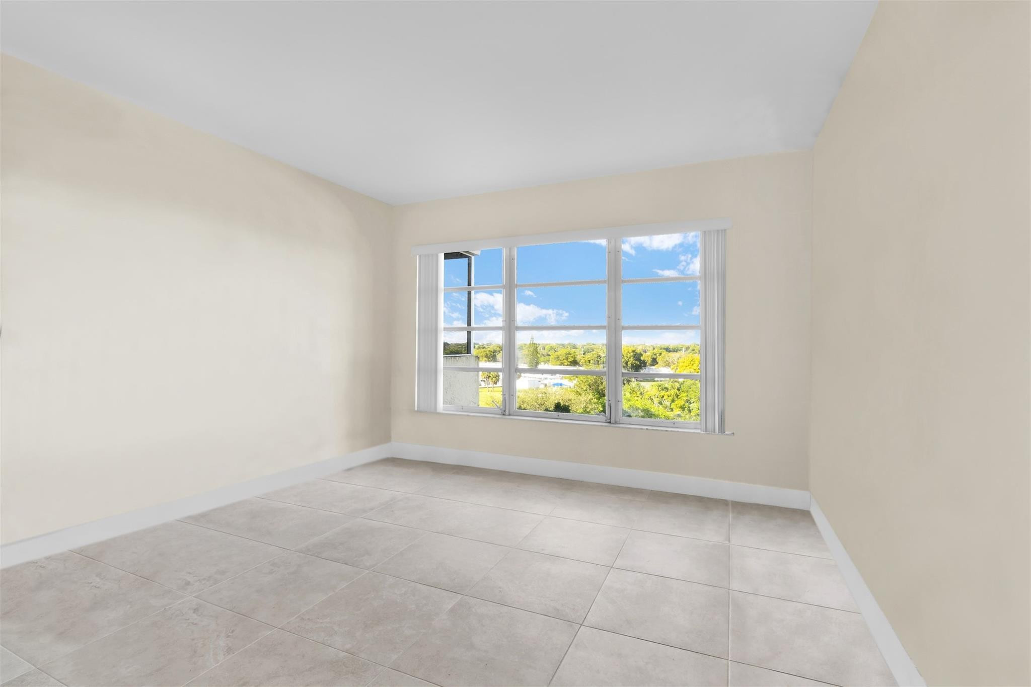 10777 West Sample Road, Unit 711 Coral Springs, FL 33065 - Photo 38 of 45 an empty room with windows