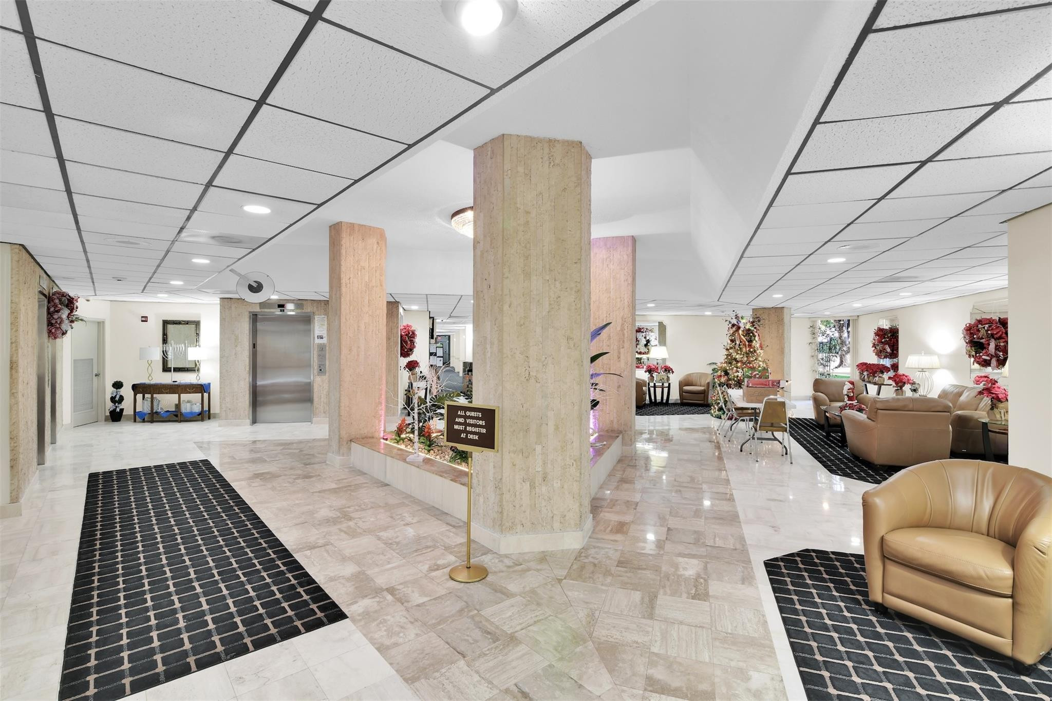 10777 West Sample Road, Unit 711 Coral Springs, FL 33065 - Photo 42 of 45 a living room with furniture and a rug