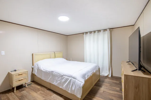 a bedroom with a bed and a television in it