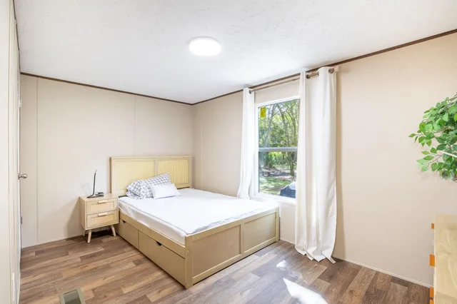 a bedroom with a bed and a window in it