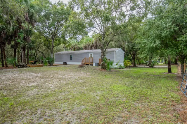 a view of a backyard with sitting area