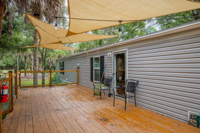 a view of a wooden dinning table and chairs in patio