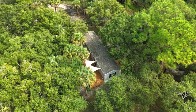 an aerial view of a house with a yard