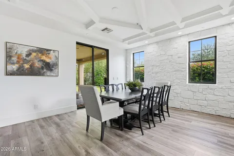 a kitchen with a sink a counter and chairs