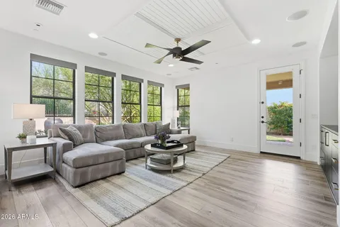 a living room with furniture and a wooden floor