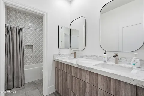 a bathroom with a sink a toilet and mirror