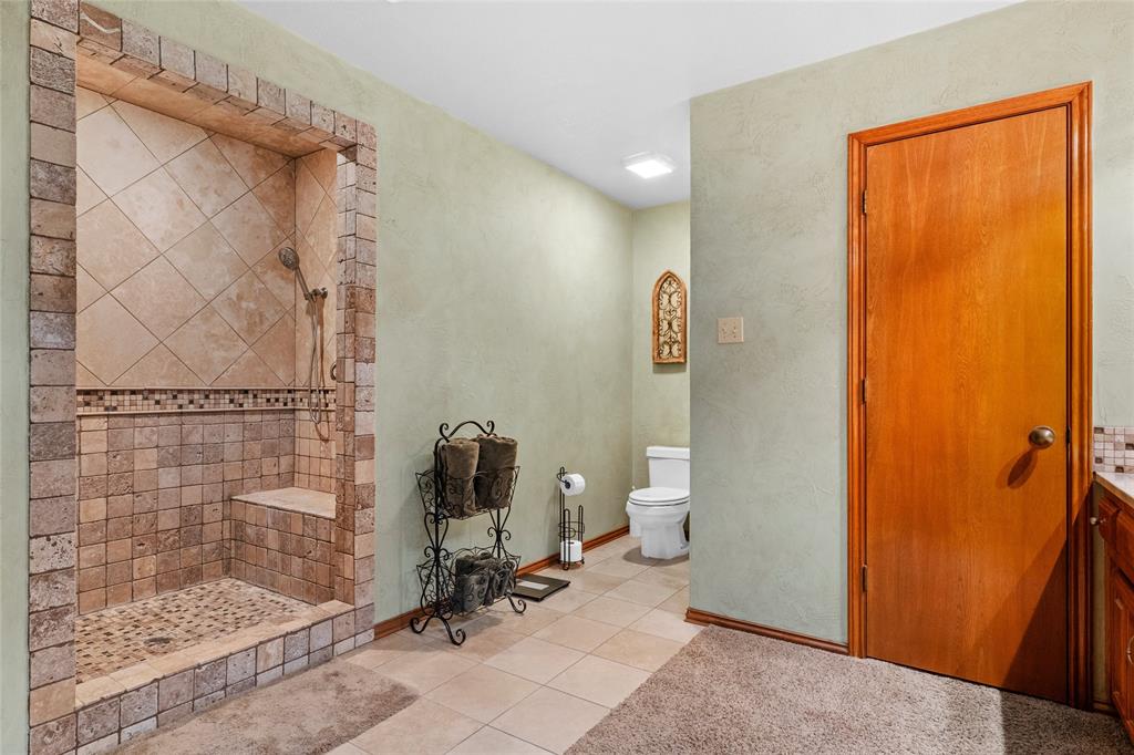 5840 Crystal Drive Midlothian, TX 76065 - Photo 23 of 36 a bathroom with a toilet and a shower