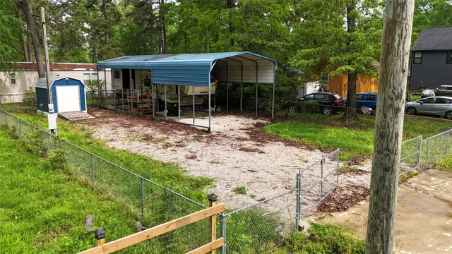 a view of a chair and table in backyard of the house