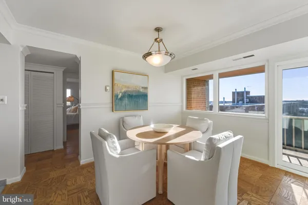 a living room with furniture a chandelier and a table