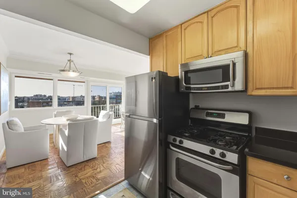 a kitchen with stainless steel appliances granite countertop a stove a refrigerator a sink and dishwasher