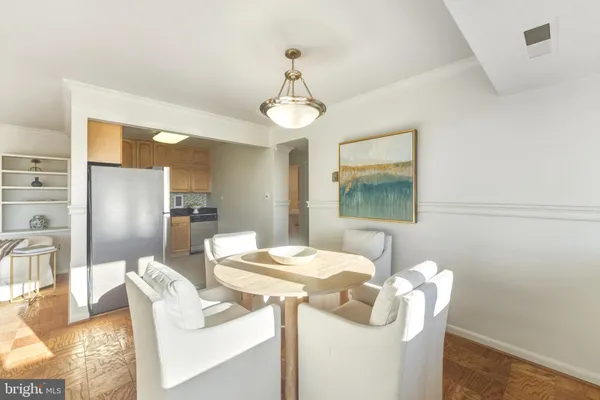a dining room with furniture a window and wooden floor