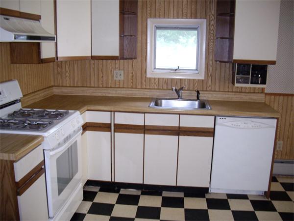 214 West Street Ware, MA 01082 - Photo 7 of 18 a kitchen with a sink a stove a microwave cabinets and a window