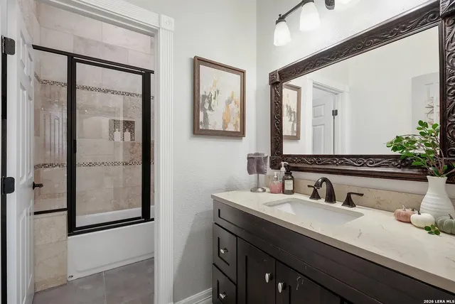 a bathroom with a double vanity sink mirror and