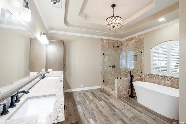 a spacious bathroom with a double vanity sink a mirror and a bathtub