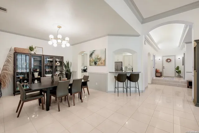 a view of a dining room with furniture and chandelier