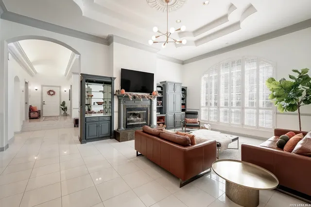 a living room with furniture a flat screen tv and a large window
