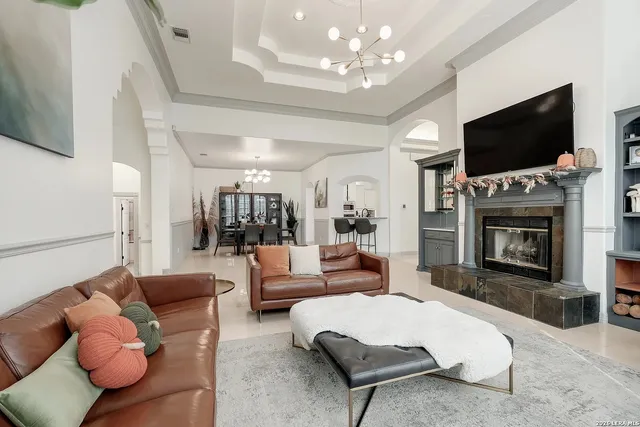 a living room with furniture a flat screen tv and a fireplace