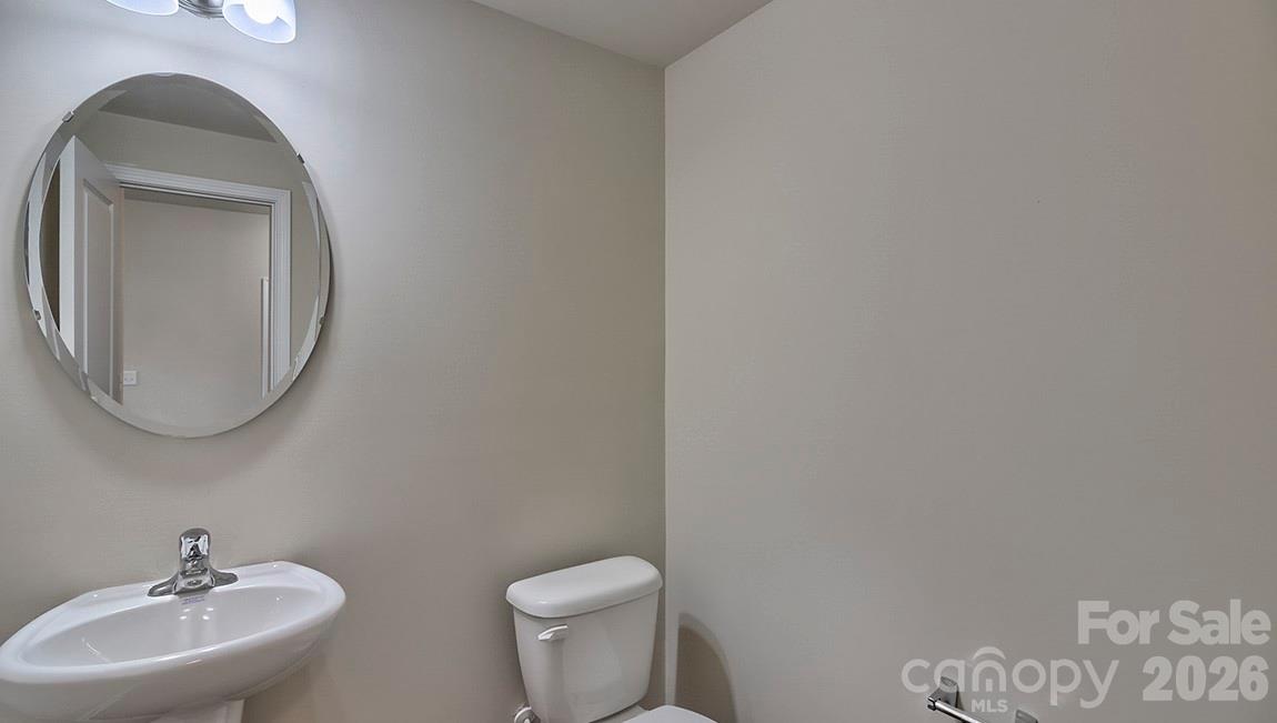 109 Piney Wds Road Fletcher, NC 28732 - Photo 13 of 28 a bathroom with a toilet a sink and mirror