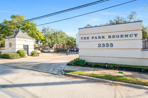 a view of a house with a yard and potted plants