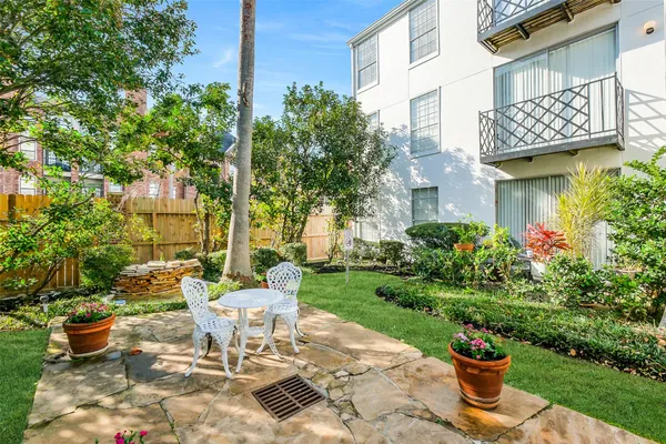 a view of a patio with plants and chairs and potted plants