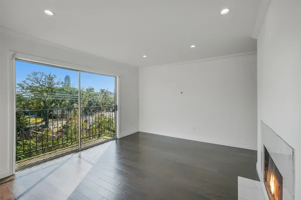 an empty room with wooden floor and a window
