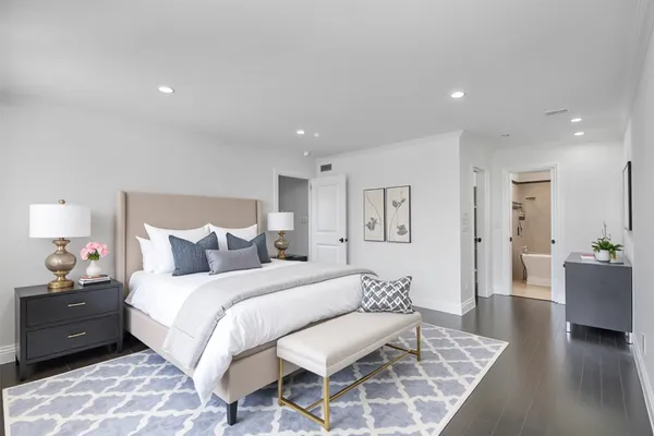 a bedroom with a bed and a couch