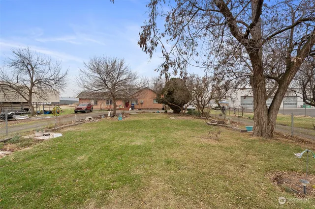 a view of a house with a patio and a yard