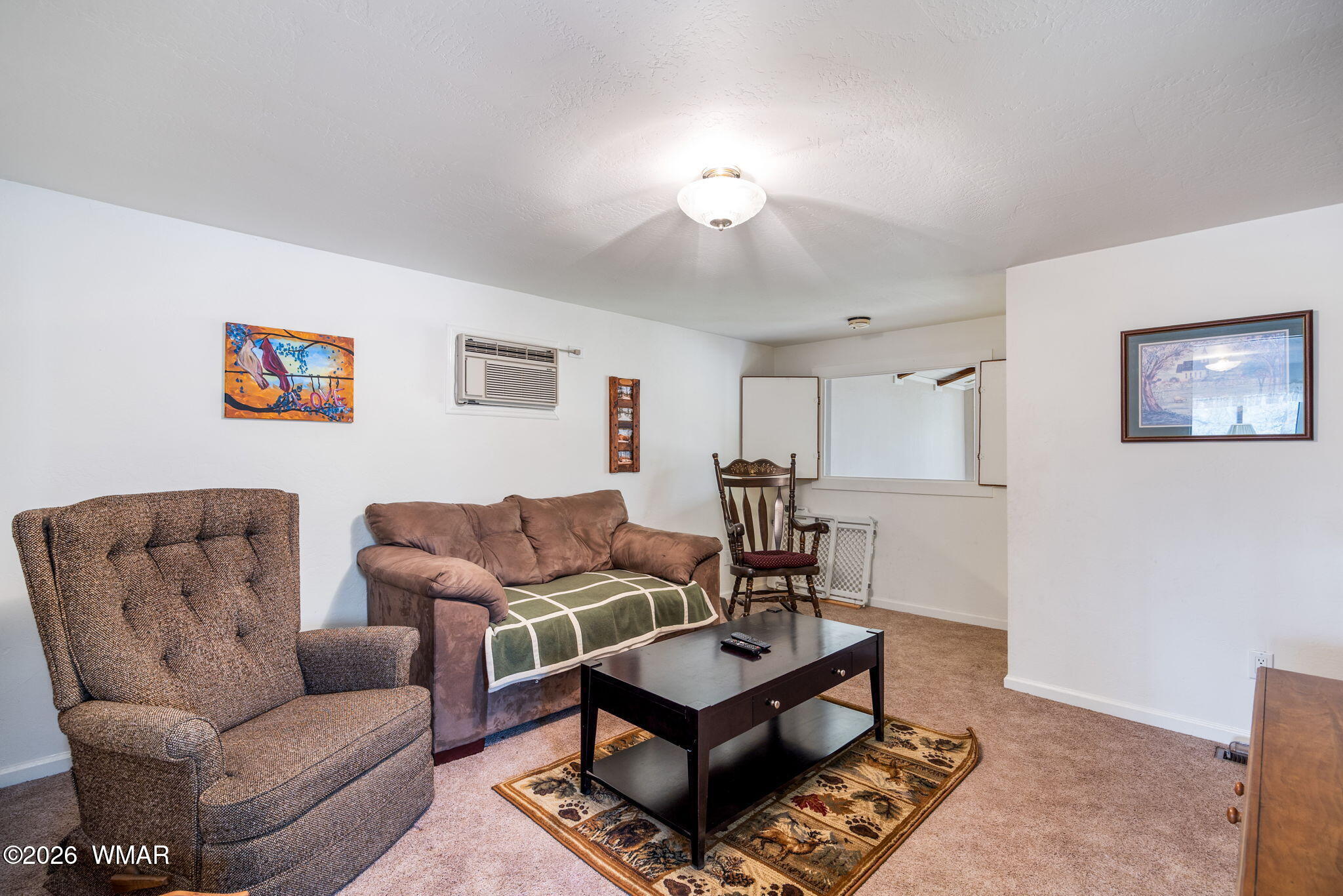 2922 Pine Rim Road Overgaard, AZ 85933 - Photo 35 of 58 a living room with furniture a rug and a window