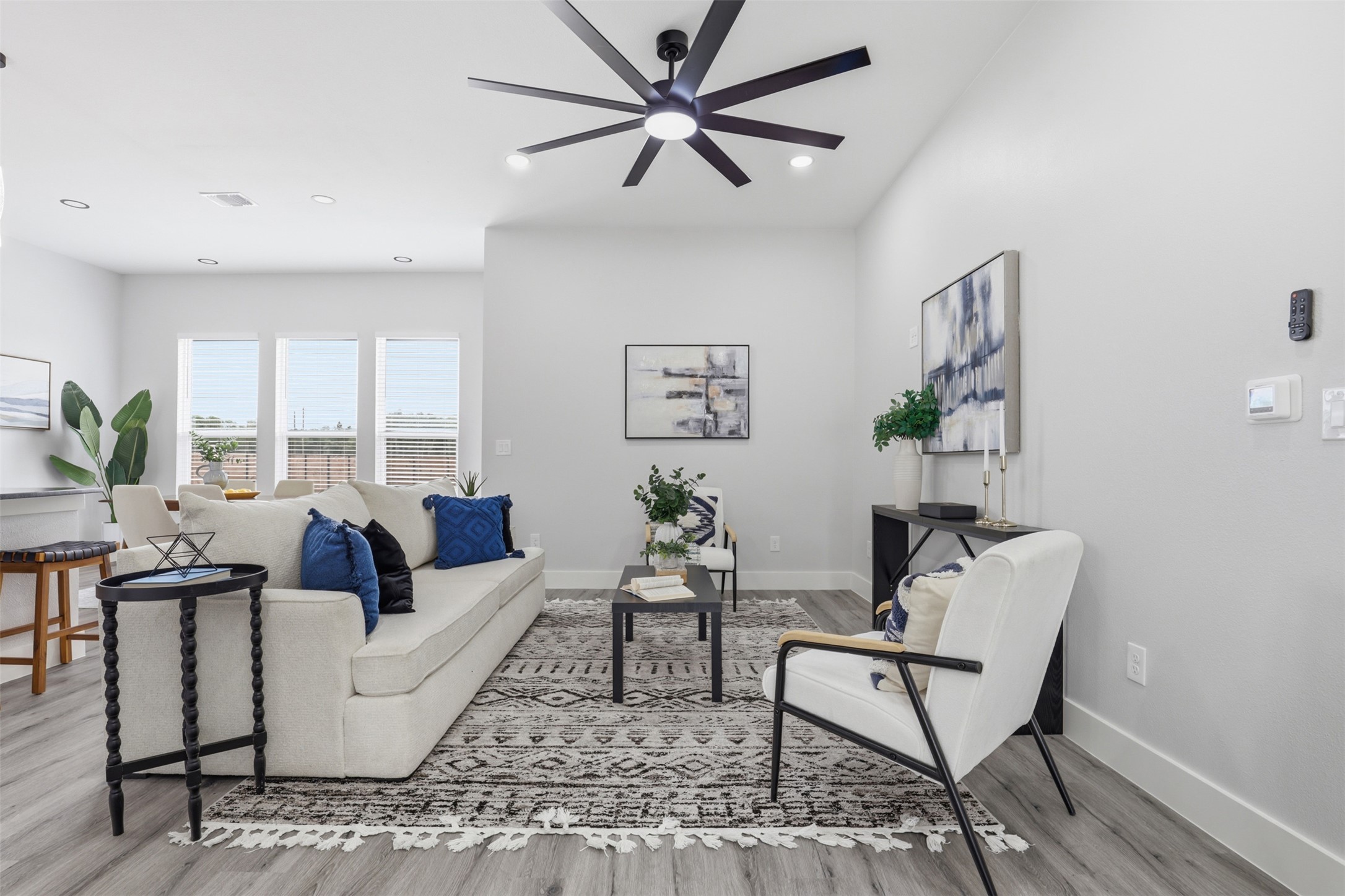 123 Los Robles Road Elgin, TX 78621 - Photo 4 of 21 Open-concept living space featuring wood-finish flooring, recessed lighting, and a modern ceiling fan