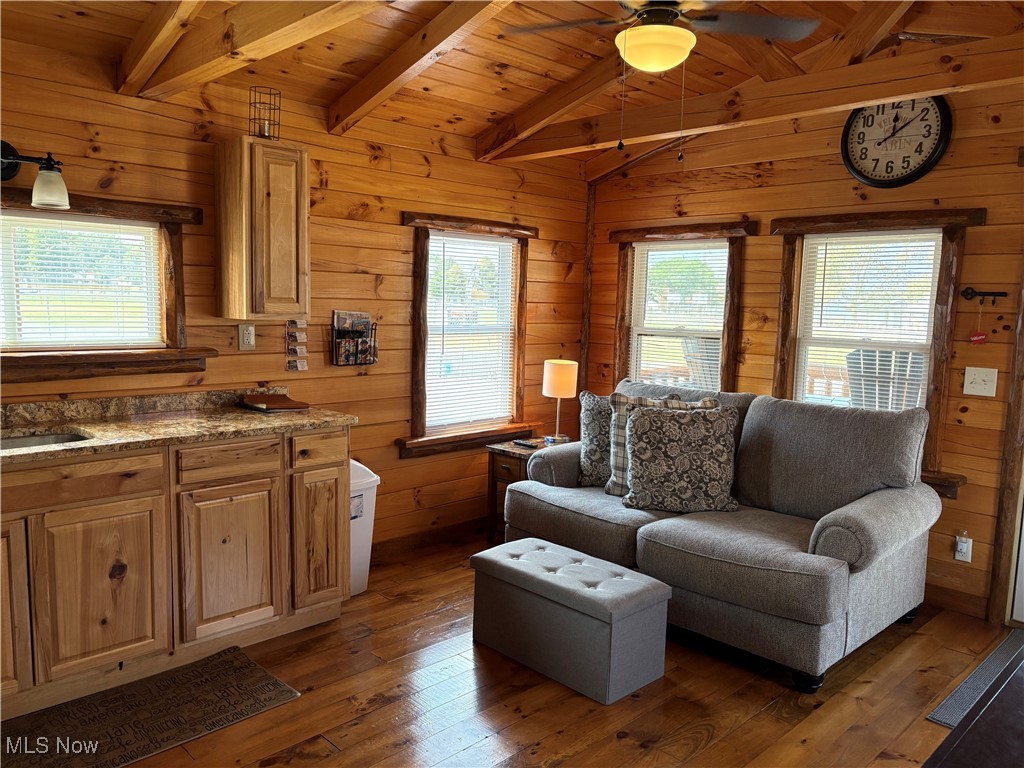 5919 Lake Road West, Unit 7 Ashtabula, OH 44004 - Photo 11 of 29 Living area with dark wood-type flooring, wooden walls, wood ceiling, and a ceiling fan