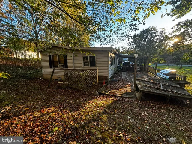 a view of a backyard with chairs and a patio