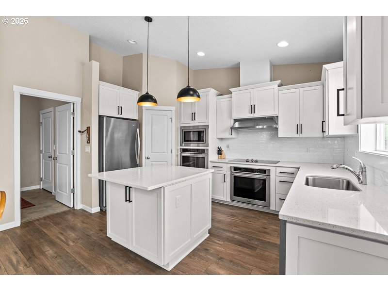 25850 Foster Road Monroe, OR 97456 - Photo 23 of 48 a kitchen with kitchen island white cabinets and stainless steel appliances