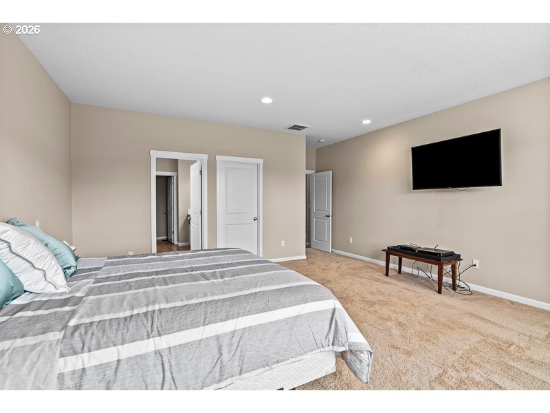 25850 Foster Road Monroe, OR 97456 - Photo 32 of 48 a bedroom with a bed and a flat screen tv
