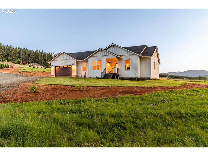 25850 Foster Road Monroe, OR 97456 - Photo 5 of 48 a front view of a house with a yard and garage