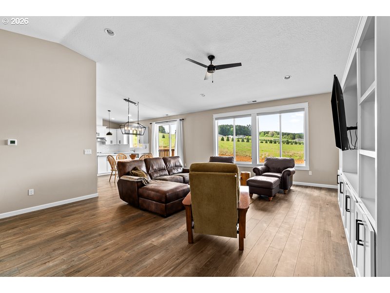 25850 Foster Road Monroe, OR 97456 - Photo 10 of 48 a living room with furniture a large window and wooden floor