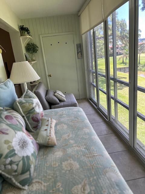 1955 Southwest Palm City Road, Unit H Stuart, FL 34994 - Photo 20 of 22 a bedroom with furniture and a large window