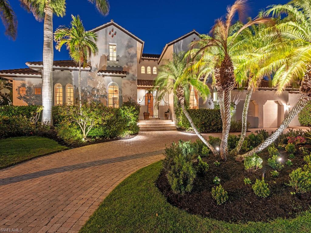 Mediterranean / spanish-style home with stucco siding, a tile roof, and decorative driveway