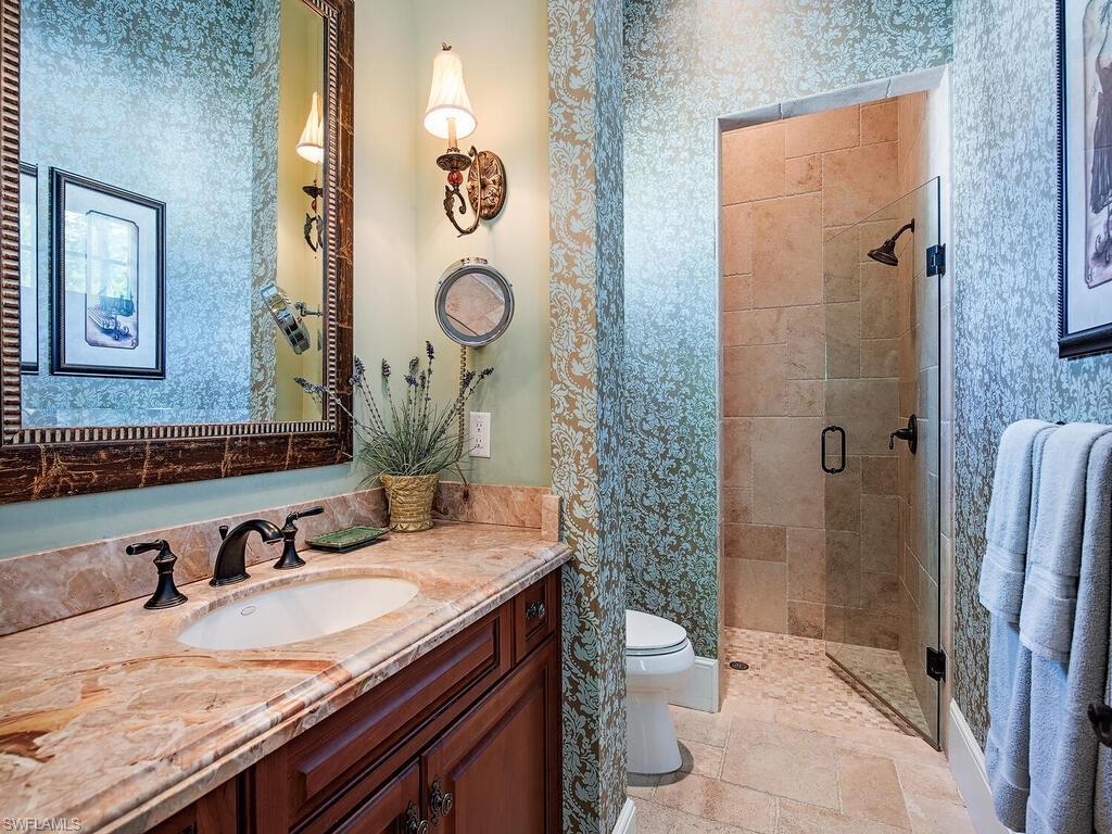 155 20th Avenue South Naples, FL 34102 - Photo 11 of 30 Bathroom featuring vanity, a shower stall, and wallpapered walls